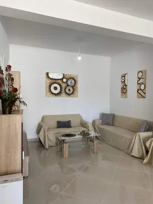 a living room with a couch and a table at Rhodes Volkshaus in Afantou