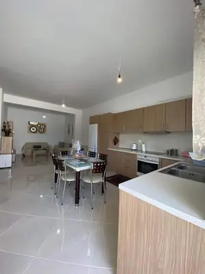a kitchen with a table and chairs and a kitchen with a tableablish at Rhodes Volkshaus in Afantou