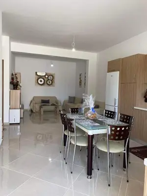 a dining room and living room with a table and chairs at Rhodes Volkshaus in Afantou