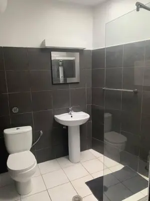 a bathroom with a toilet and a sink and a shower at Laokoontos 16 in Rhodes Town