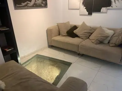 a living room with a couch and a rug at Laokoontos 16 in Rhodes Town
