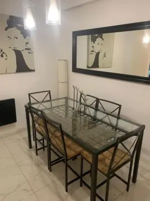 a glass table with four chairs in a room at Laokoontos 16 in Rhodes Town