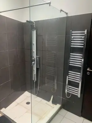 a shower with a glass door in a bathroom at Laokoontos 16 in Rhodes Town