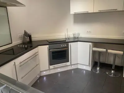 a kitchen with white cabinets and a stove at Laokoontos 16 in Rhodes Town