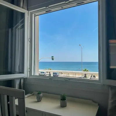 a window with a view of the beach at Alios apartment in Rhodes Town