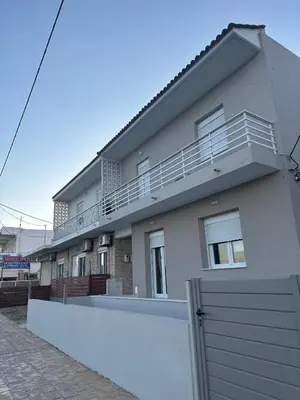 a white house with a fence in front of it at Alios apartment in Rhodes Town