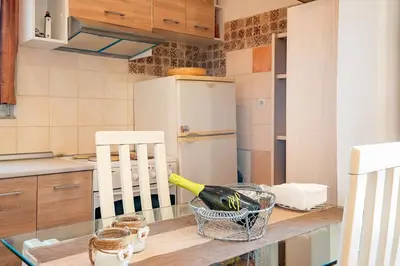 a kitchen with a table with a bottle of wine at Ciel Rhodes in Rhodes Town