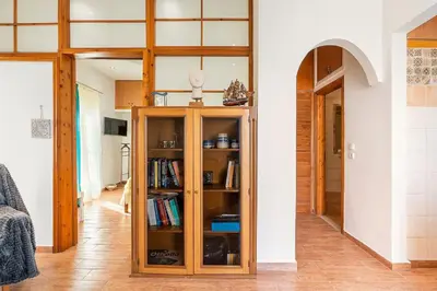 a room with a book shelf with books at Ciel Rhodes in Rhodes Town