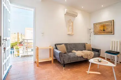 a living room with a couch and a table at Ciel Rhodes in Rhodes Town