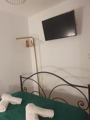 a room with a bed with two towels on a table at Aggeliki's House in Symi