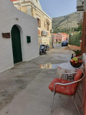 a table with a bowl of fruit on top of it at Aggeliki's House in Symi