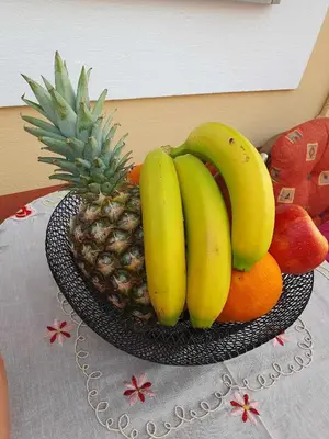 a bowl of bananas and fruit on a table at Aggeliki's House in Symi