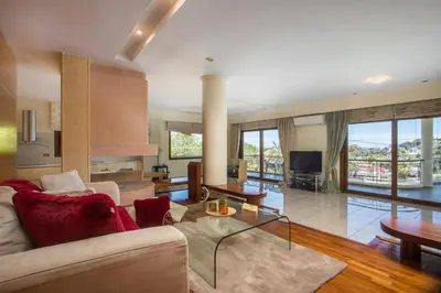 a living room with a couch and a table at Luxury Villa Amaltheia Rhodes in Koskinou