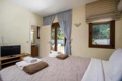 a bedroom with a bed with towels on it at Luxury Villa Amaltheia Rhodes in Koskinou