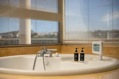 a bathroom with a bath tub with two bottles of soap at Luxury Villa Amaltheia Rhodes in Koskinou