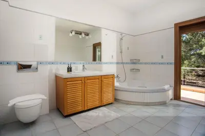 a bathroom with a tub and a toilet and a sink at Luxury Villa Amaltheia Rhodes in Koskinou