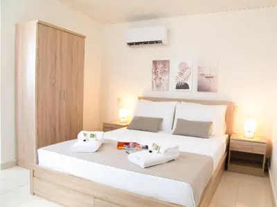 a bedroom with a bed with two towels on it at SunView Studio in Kremasti