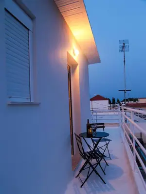 a patio with a table and chairs on a balcony at SunView Studio in Kremasti