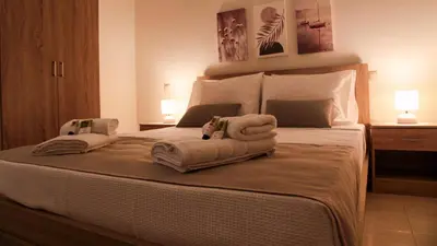a bedroom with a bed with towels on it at SunView Studio in Kremasti