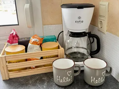 a kitchen counter with two coffee mugs and a mixer at SunView Studio in Kremasti