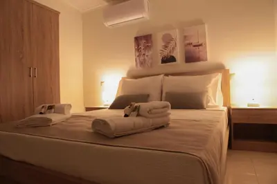 a bedroom with a bed with towels on it at SunView Studio in Kremasti
