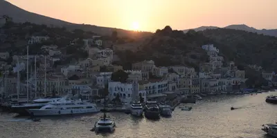 a group of boats docked in a harbor at sunset at Marea Studios in Symi