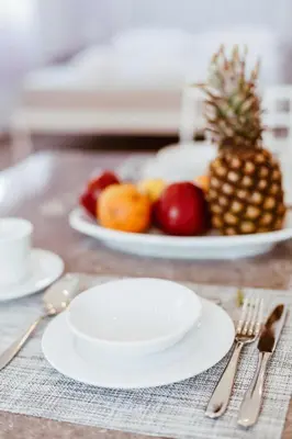 a table with two plates of fruit on a table at Marea Studios in Symi