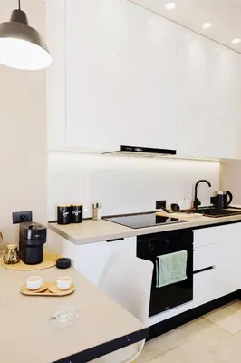 a kitchen with white counters and a black stove top oven at Casa Napais Earth Retreat in Archangelos