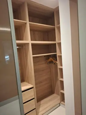 a walk in closet with wooden doors and shelves at Prifti Luxury apartment in Faliraki
