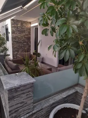 a courtyard with potted plants in a house at Prifti Luxury apartment in Faliraki