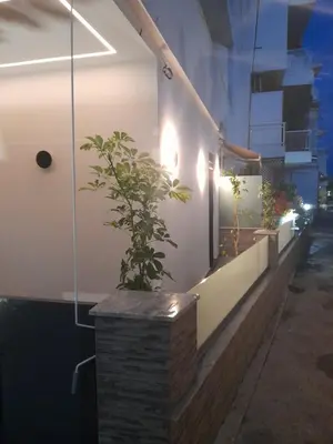 a plant in a brick planter on a wall with lights at Prifti Luxury apartment in Faliraki