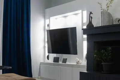 a living room with a tv and a fireplace at Paradise Apartment, Lardos Village in Lardos