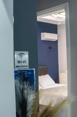 a bedroom with a bed and a mirror in a room at Paradise Apartment, Lardos Village in Lardos