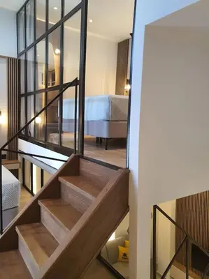 a staircase leading to a room with a bedroom at Koloniale Loft House in Rhodes Town