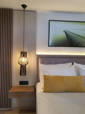 a bedroom with a bed with a lamp and a picture at Koloniale Loft House in Rhodes Town