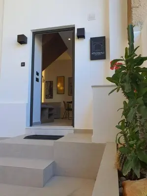 a hallway of a house with a door and a plant at Koloniale Loft House in Rhodes Town