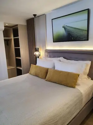 a bedroom with a large bed with a television on the wall at Koloniale Loft House in Rhodes Town