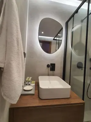 a bathroom with a white sink and a mirror at Koloniale Loft House in Rhodes Town