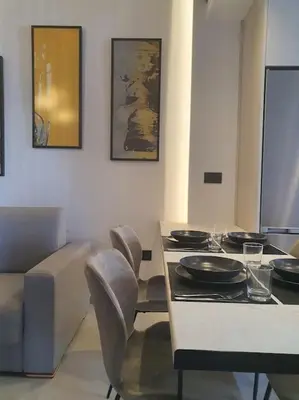 a dining room with a table and chairs with plates on it at Koloniale Loft House in Rhodes Town