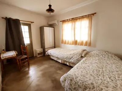 a bedroom with two beds and a window at Απόλλων in Apóllona