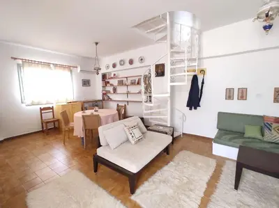 a living room with a couch and a table at Απόλλων in Apóllona