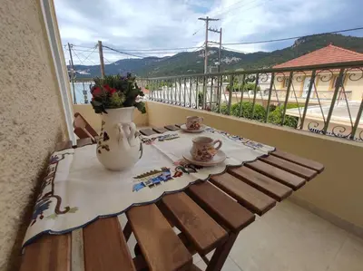 a table on a balcony with a vase on it at Απόλλων in Apóllona