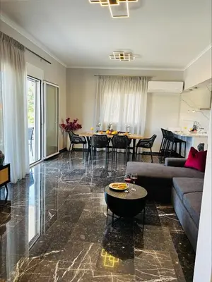 a living room with a couch and a table at Flev's House with Jacuzzi & Rooftop BBQ in Kremasti