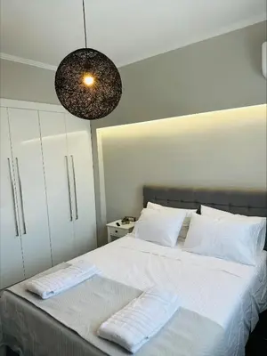 a bedroom with a bed with two towels on it at Flev's House with Jacuzzi & Rooftop BBQ in Kremasti