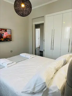 a bedroom with a large white bed in a room at Flev's House with Jacuzzi & Rooftop BBQ in Kremasti