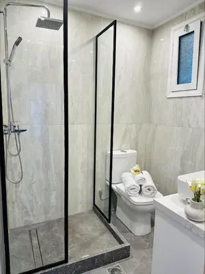 a bathroom with a shower with a toilet and a sink at Flev's House with Jacuzzi & Rooftop BBQ in Kremasti