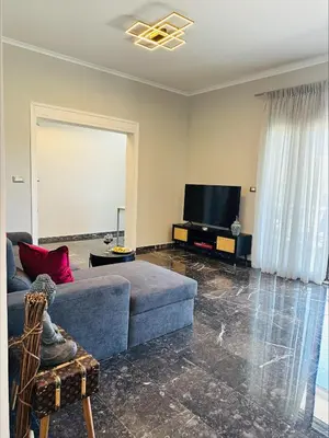 a living room with a couch and a flat screen tv at Flev's House with Jacuzzi & Rooftop BBQ in Kremasti