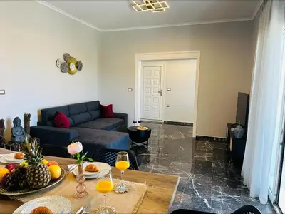 a living room with a couch and a table with wine glasses at Flev's House with Jacuzzi & Rooftop BBQ in Kremasti