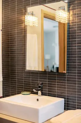 a bathroom with a white sink and a mirror at Alonia View House in Asklipiḯon