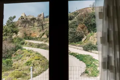 a view of a dirt road from a window at Alonia View House in Asklipiḯon
